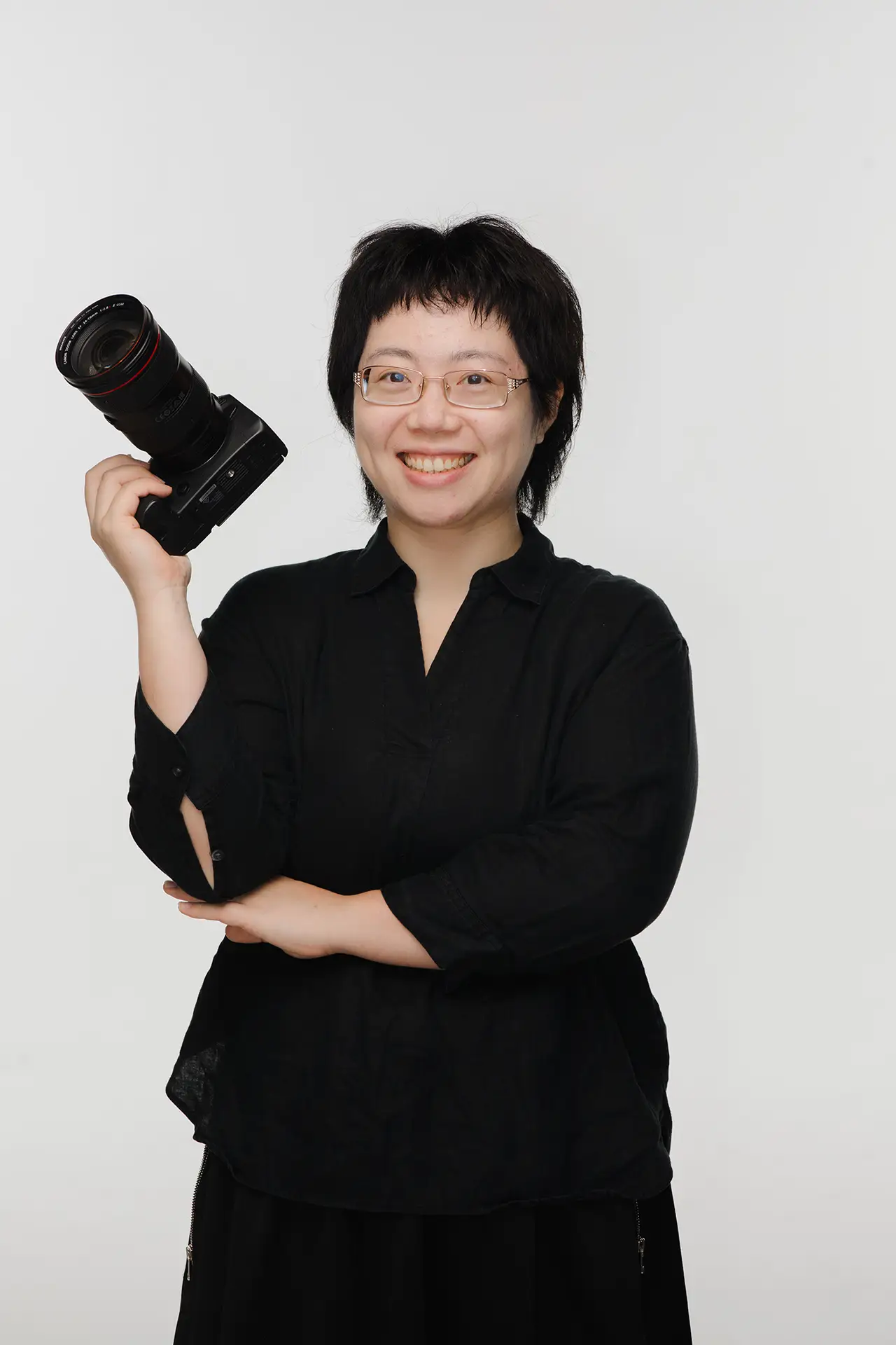 photo of a wedding photographer holding a camera, shot in studio