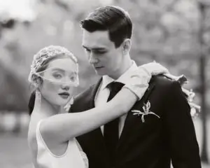 Photo of bride and groom at with arms around each other at Fitzroy Gardens, Melbourne